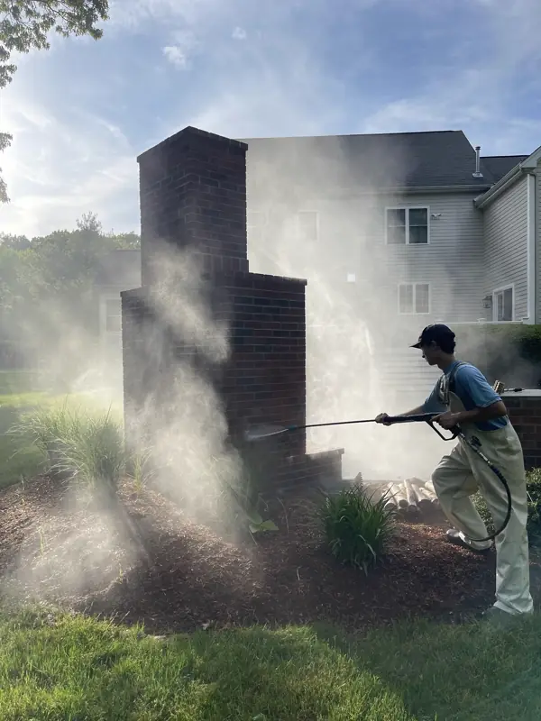 Callahan crew member soft washing a brick chimney