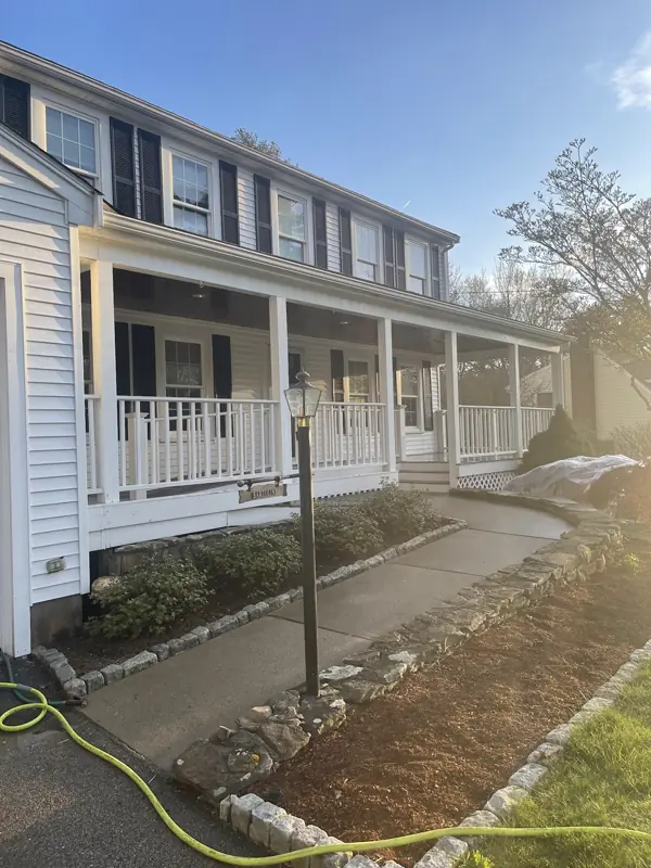 Clean white colonial and walkway after a soft wash
