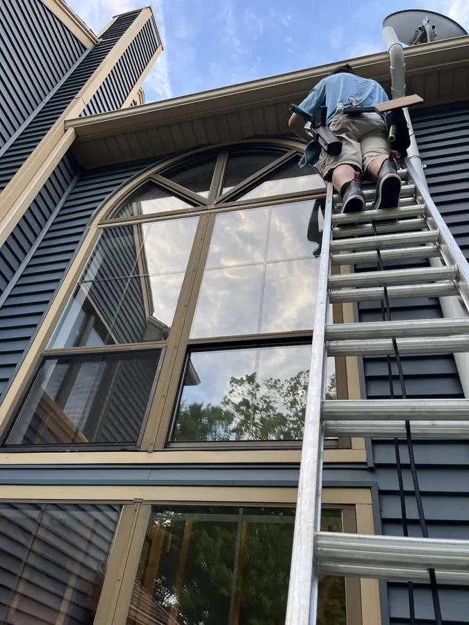 Window cleaning at a tall arched window